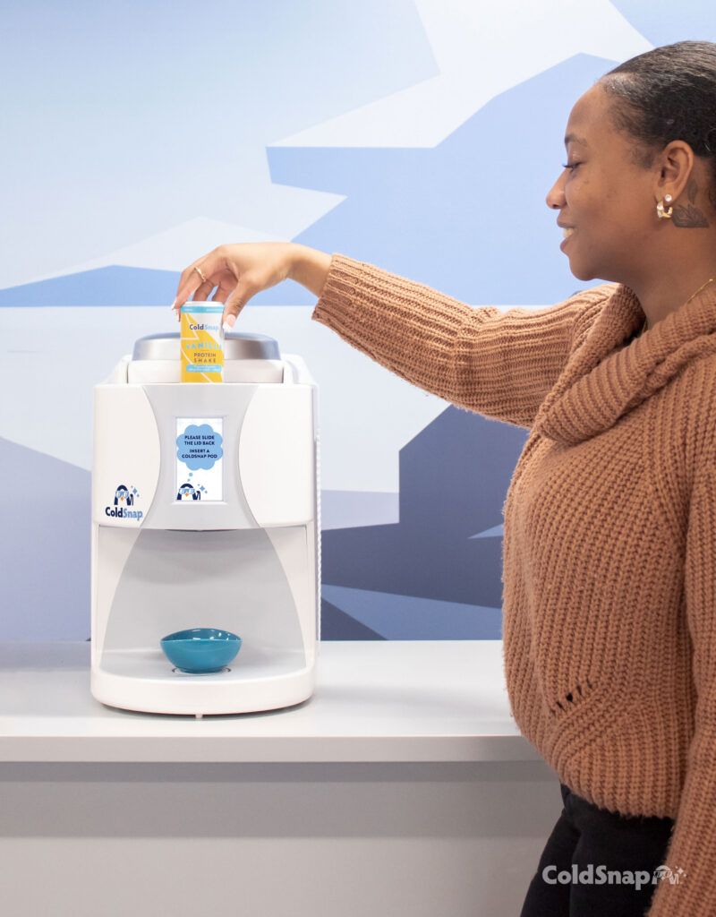 A woman loading a ColdSnap canister into a ColdSnap Ice Cream Machine - Avcoa Vending Chicago, IL