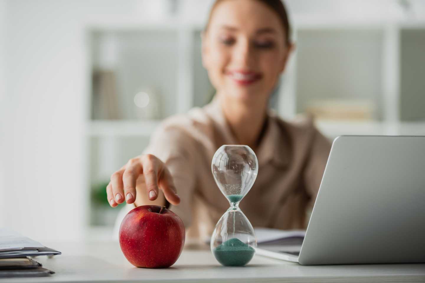 A woman in an office reaches for a delicious red apple from the office pantry in her workplace. Avcoa Vending in Chicago, IL.