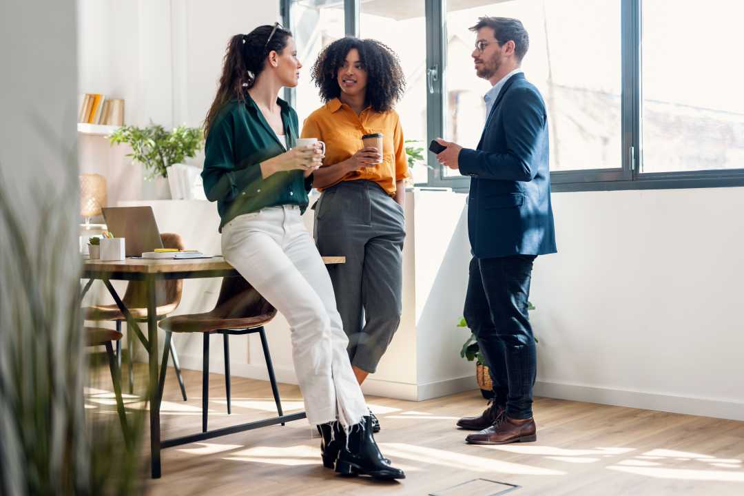 A group of coworkers enjoying coffee in their office. Office Vending Services​ from Avcoa Vending, Chicago, IL.