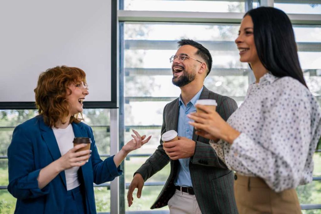 Coworkers enjoying office coffee together in their workplace break room. Office Coffee Service​ from Avcoa Vending, Chicago, IL.