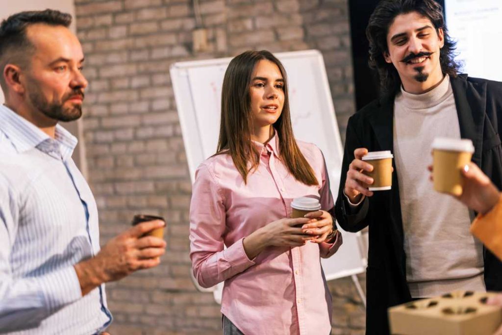 Coworkers enjoying coffee together in their office break room. Modern coffee machines and Office Coffee Service​ from Avcoa Vending, Chicago, IL.