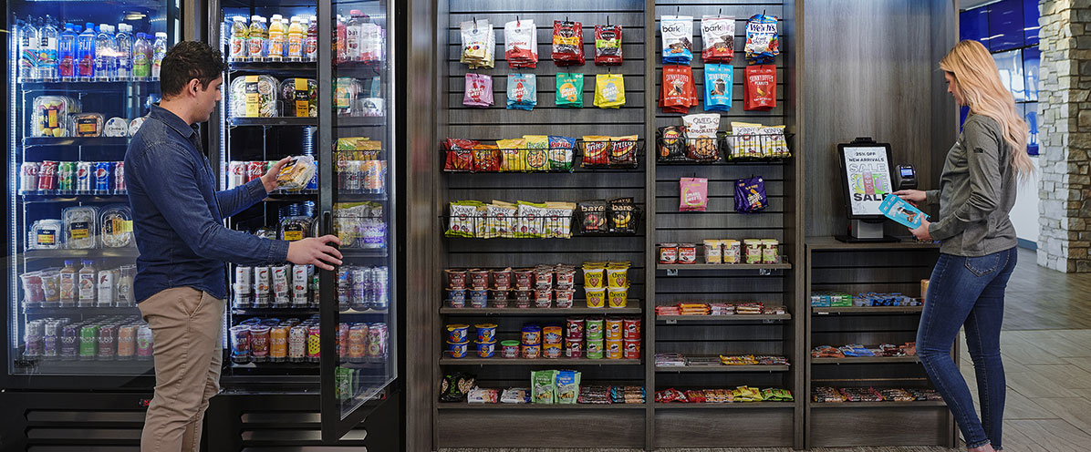 Co-workers select and pay for their items at a modern micro market provided by Avcoa Vending in Chicago, IL.